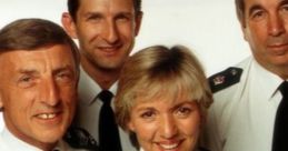 Cast of "The Bill" smiling in uniform, showcasing camaraderie among iconic British police drama characters.