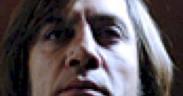 Close-up of Anton Chigurh from No Country for Old Men, capturing his intense and menacing expression in low lighting.