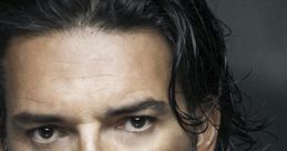 Ricardo Arjona's intense gaze and signature style highlight his captivating presence in Latin music.