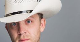 Justin Moore in a stylish black leather jacket and white cowboy hat, showcasing his signature country artist look.