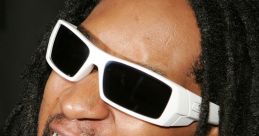 Lil Jon energetically shouting, wearing oversized sunglasses and grill, showcasing his iconic style and vibrant personality.