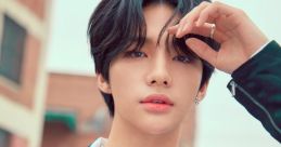 Hyunjin from Stray Kids poses confidently outdoors, showcasing a stylish look with a sleek jacket and silver accessories.