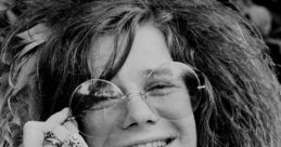 Janis Joplin smiling, adorned with bracelets and stylish sunglasses, capturing her iconic 1960s rock and roll spirit.