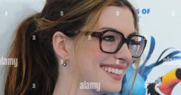 Anne Hathaway smiling in stylish attire, promoting "Rio" as the voice of Jewel, showcasing her vibrant personality.