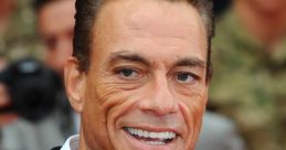 Jean-Claude Van Damme smiles at a red carpet event, showcasing his charismatic persona and stylish black suit.