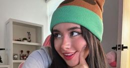 Mexican streamer PipePunk poses playfully in a unique beanie, showcasing her vibrant personality and stylish look.