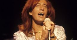 Robin Gibb passionately performing on stage, showcasing his iconic style and vocal talent as a member of the Bee Gees.