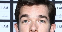 John Mulaney at an event, showcasing his comedic style and charm, connected to Spider-Ham character from animated films.