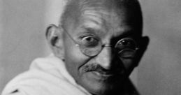 Mahatma Gandhi smiling, wearing traditional attire, embodying peace and nonviolent resistance in black and white photography.