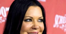 Smiling woman with dark hair and a star-shaped pendant, celebrating at a glamorous event with a vibrant background.