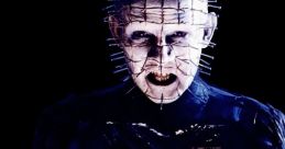 Pinhead from Hellraiser, holding a mysterious box that emanates eerie light, showcasing his menacing presence.