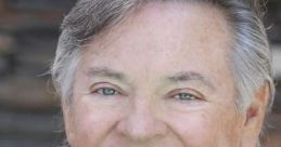 Frank Welker, renowned voice actor known for Garfield, smiles warmly in a professional setting, showcasing his signature style.