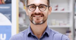 Friendly British pharmacist in a pharmacy, promoting health and wellness with professional expertise.