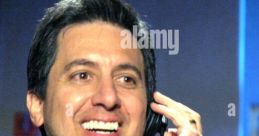 Ray Romano smiling while speaking into a headset, known for voicing Manny in Ice Age. Engaging and upbeat expression.