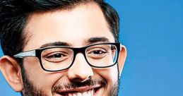 CarryMinati smiling in a vibrant floral shirt against a blue background, showcasing his charismatic personality.