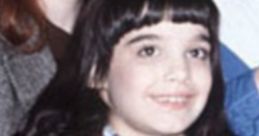 Young girl with dark hair and a golden jacket, smiling, representing Danielle Brisebois during her early career.