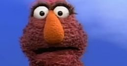 Telly Monster, a beloved character voiced by Martin P. Robinson, displaying curiosity with a vibrant red fur coat.