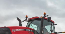 Red Case IH Magnum 380 tractor on a field, showcasing powerful tires and modern agricultural design for efficient farming.