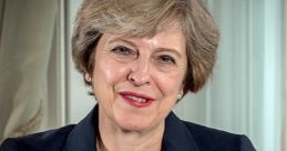 Theresa May smiling in a formal setting, dressed in a dark suit with pearl necklace, showcasing her leadership presence.