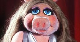 Miss Piggy from Sesame Street in an elegant silver dress, showcasing her iconic style with glamorous gloves and a floral brooch.