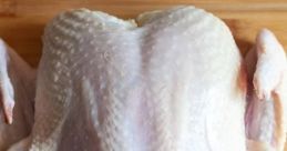 Raw, fresh Twurkey ready for preparation on a wooden cutting board, ideal for festive meals and gatherings.