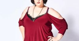 Nessa from Gavin & Stacey poses confidently in a stylish outfit, showcasing her bold fashion sense and personality.