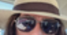 Individual wearing a wide-brimmed hat and sunglasses, embodying the laid-back vibe of Mungo Matty Mouthfulls.