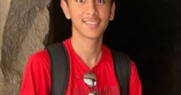 Kavin Jain smiling and posing in a red graphic t-shirt with a stunning background, showcasing vibrant youthful energy.