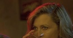 Woman sipping a drink in a dimly lit bar, capturing the atmospheric essence of the film "Barfly.