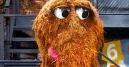 Mr. Snuffleupagus, the beloved Sesame Street character, stands with a fuzzy coat and big expressive eyes in a vibrant setting.