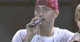 Eminem performs "Stan (Long Version)" with Dido, showcasing his iconic style and powerful vocals on stage.