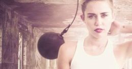 Miley Cyrus in "Wrecking Ball" Director's Cut, showcasing her iconic look and emotional intensity against a dramatic backdrop.