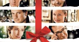 Cast of "Love Actually" (2003) against a festive backdrop with a red bow, capturing the essence of holiday romance.