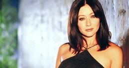 Shannen Doherty in a stylish black outfit, exuding confidence and charm, reminiscent of her roles in drama series.