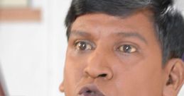 Vadivelu in a colorful shirt, dramatically expressing emotions, showcasing his unique comedic style and charisma.