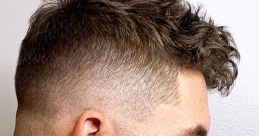 Stylish fade haircut with textured curls on top, showcasing a clean skin fade on the sides for a trendy look.