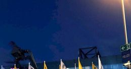 Deluta branding visible on flags outside a venue, with a telehandler in the foreground and evening lighting.