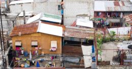 Overhead view of a densely populated slum area with makeshift homes, rusty roofs, and hanging laundry.