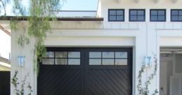 Stylish modern garage doors with decorative landscaping and stone walkway, enhancing curb appeal and functionality.