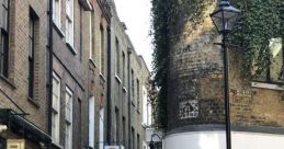 Charming alleyway with traditional brick buildings, shop signs, and a lamppost, creating a quaint urban atmosphere.