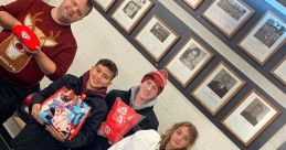 Group of youth hockey players and coach smiling, holding gifts and bags at a community event, showcasing teamwork and joy.