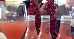 Refreshing Bellini cocktail served in a glass with Canella-branded bottled drinks, perfect for festive gatherings.