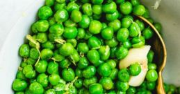 Fresh green peas mixed with garlic and spices in a bowl, showcasing vibrant color and healthy ingredients. Perfect for salads.