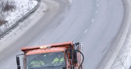 Snowplow clearing a snowy road, ensuring safe winter travel with effective snow removal techniques.