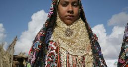 Siwan woman in traditional dress, showcasing intricate embroidery and vibrant colors, reflecting Siwa's rich cultural heritage.