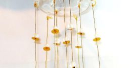 Elegant golden bell chime hanging decor with shimmering bells and decorative beads, perfect for enhancing ambiance.