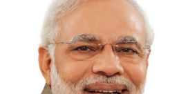 Portrait of Narendra Modi smiling, wearing a traditional outfit, promoting leadership and Indian culture.