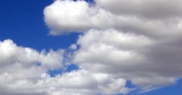 Majestic Mongolian mountains under a bright blue sky with fluffy white clouds, showcasing nature's serene beauty.