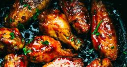 Deliciously glazed chicken wings, perfectly cooked with a glossy finish, garnished with fresh herbs for added flavor.