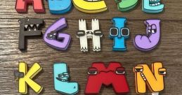 Colorful Alphabet Lore letters arranged on a wooden surface, showcasing playful designs and characters for educational fun.